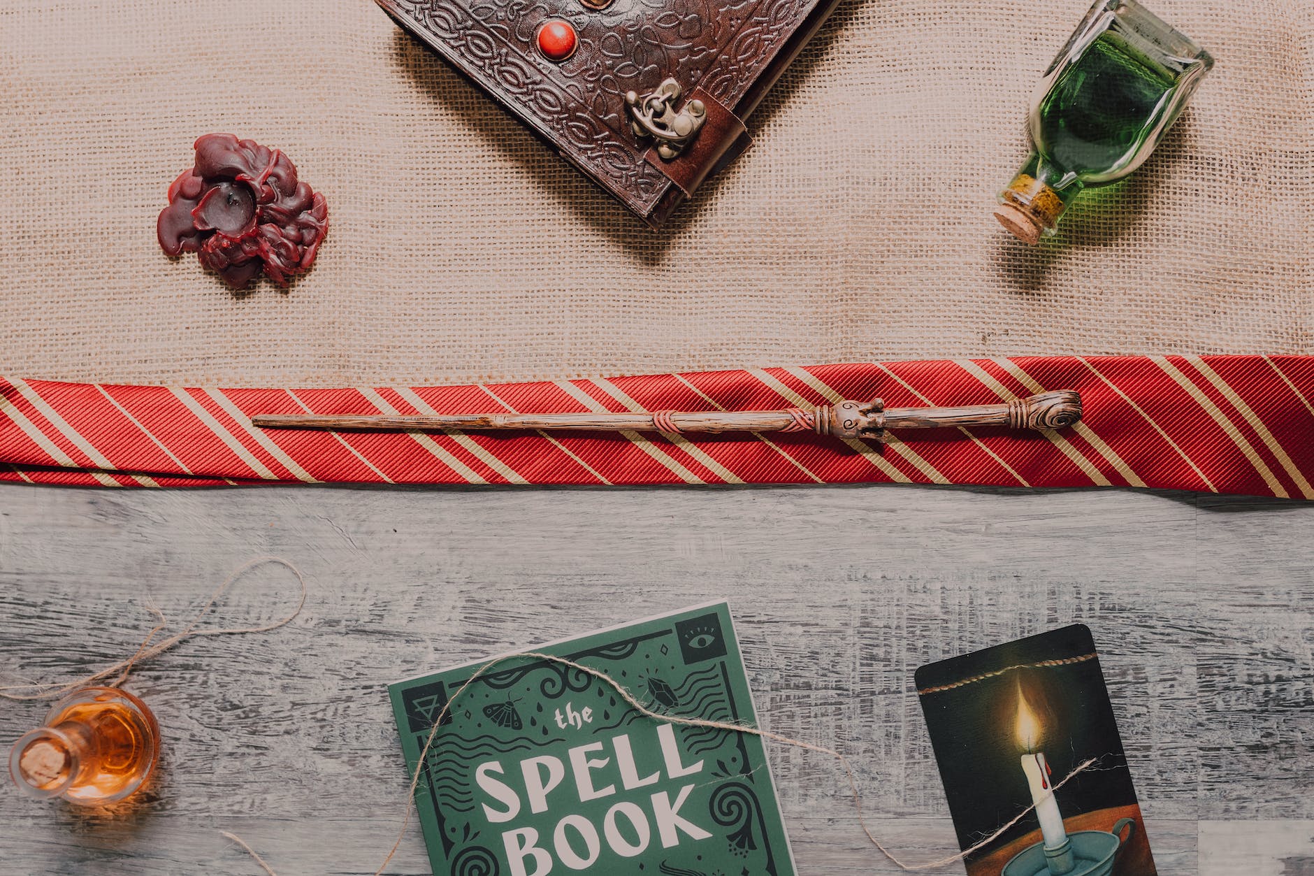 close up shot of a wand beside a spell book